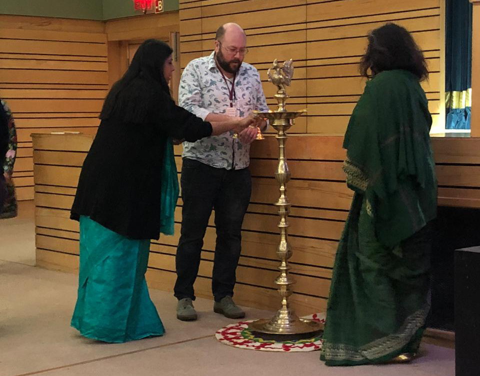 P.G. Bell lighting a ceremonial lamp at Shri Ram school