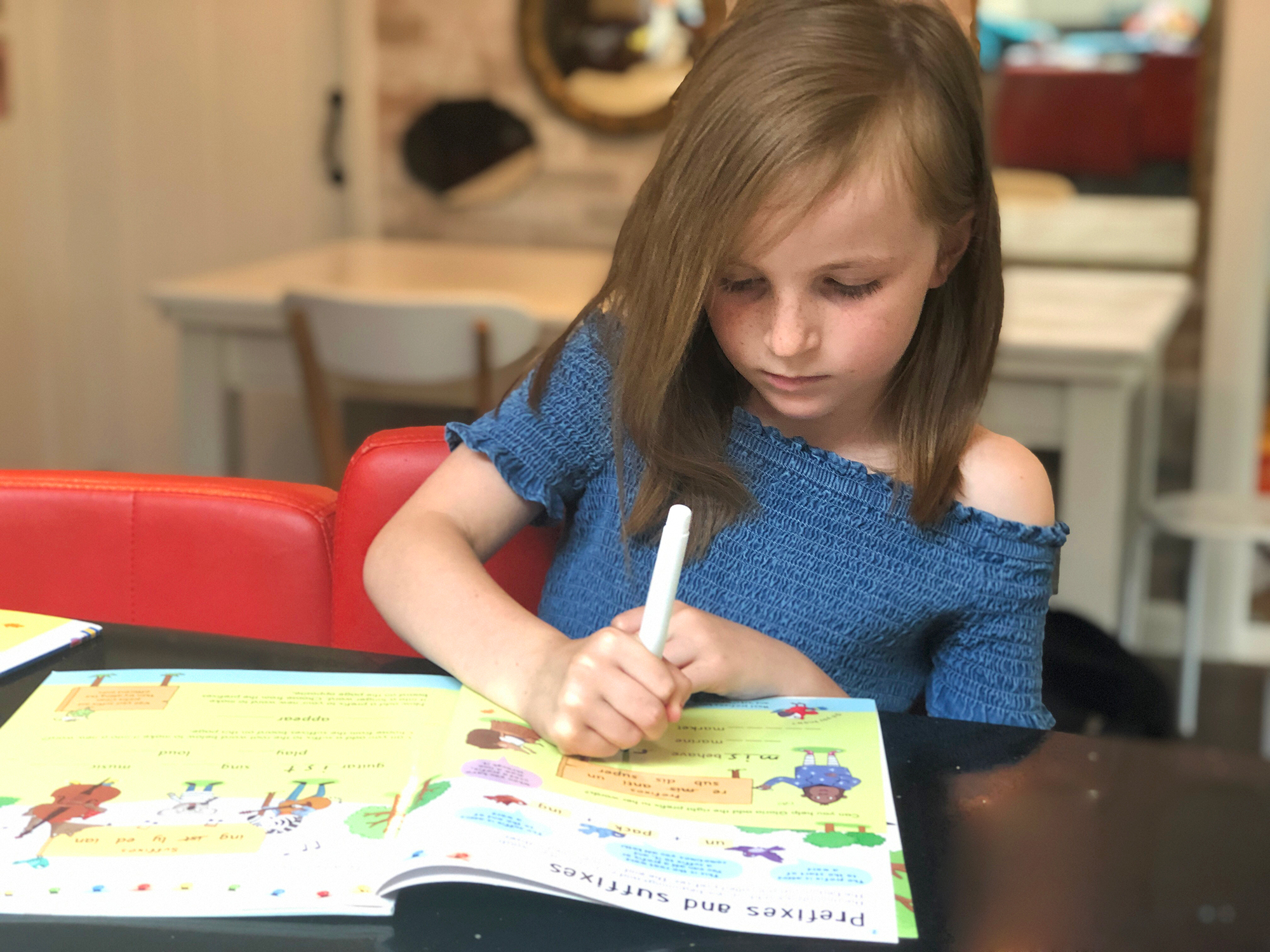 Child practising an Usborne Key Skills book